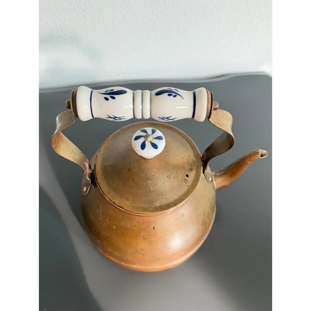 Vintage copper tea kettle with hand-painted blue and white porcelain handle lid